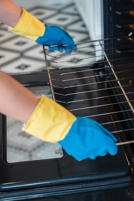 Close-up view of a stainless steel oven with a digital control panel showing various buttons and a display, situated in a kitchen setting with a modern design. The oven door is closed, and the surface
